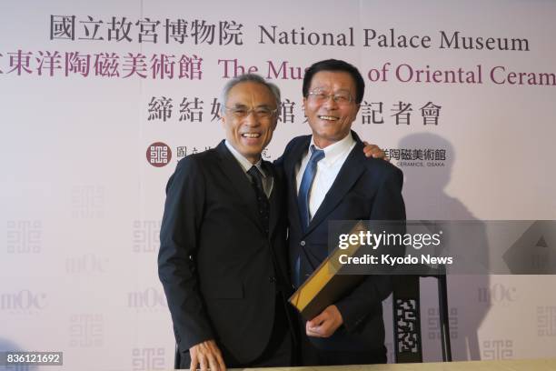 Tetsuro Degawa , director of the Museum of Oriental Ceramics, Osaka, and Jasper Lin, director of Taiwan's National Palace Museum, pose for photos in...