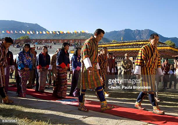 His Majesty Jigme Khesar Namgyel Wangchuck walks behind his father, former King Jigme Singye Wangchuck as they leave during a coronation celebration,...