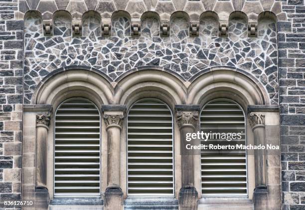 Trinity College Gothic Revival design and architectural features of the vintage walls. Arched windows . The building belongs to the Saint George...
