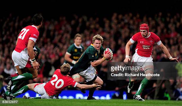 Jean De Villiers of South Africa is tackled by Dwayne Peel of Wales during the Invesco Perpetual Series match between Wales and South Africa at the...