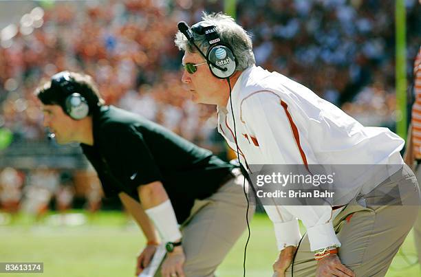 Head coach Mack Brown and defensive coordinator Will Muschamp of the Texas Longhorns watch their team make a defensive stand against the Baylor Bears...