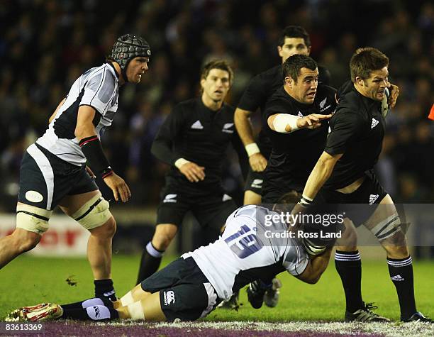 Richie McCaw of the All Blacks is tackled Scott Gray during the rugby match between Scotland and New Zealand All Blacks at Murrayfield on November...