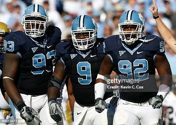 Cam Thomas, Marvin Austin and E.J. Wilson of the North Carolina Tar Heels celebrate after a defensive stop against the Georgia Tech Yellow Jackets...