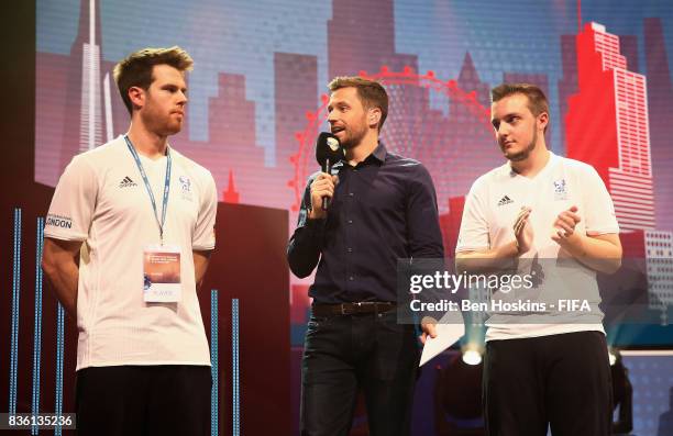 Presenter Spencer Owen talks to Kai 'Deto' Wollin of Germany and Spencer 'Gorilla' Ealing of England prior to the final during day three of the FIFA...