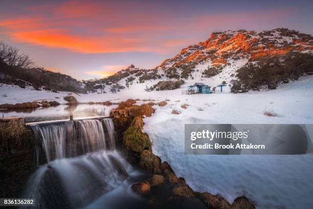 waterfall and snowy mountain sunset. - winter australia stockfoto's en -beelden