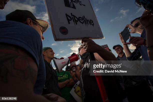Demonstrators argue with a counter demonstrator holding a sign during an 'America First' demonstration on August 20, 2017 in Laguna Beach,...