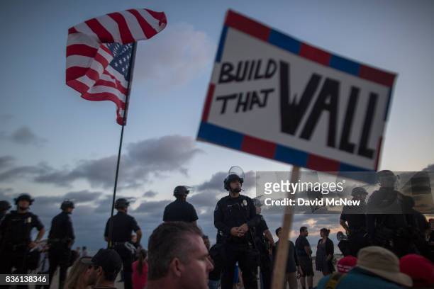 Police form a line on the boardwalk to keep demonstrators and counter demonstrators apart during an 'America First' demonstration on August 20, 2017...
