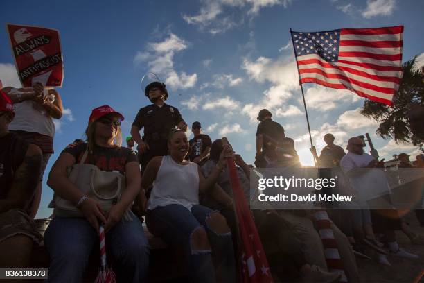 Conservative demonstrators rally as police form a line to keep them from clashing with counter demonstrators during an 'America First' demonstration...