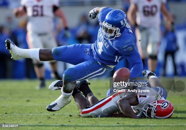 Mohamed Massaquoi of the Georgia Bulldogs fumbles the ball after being hit by Micah Johnson of the kentucky Wildcats during the game at Commonwealth...