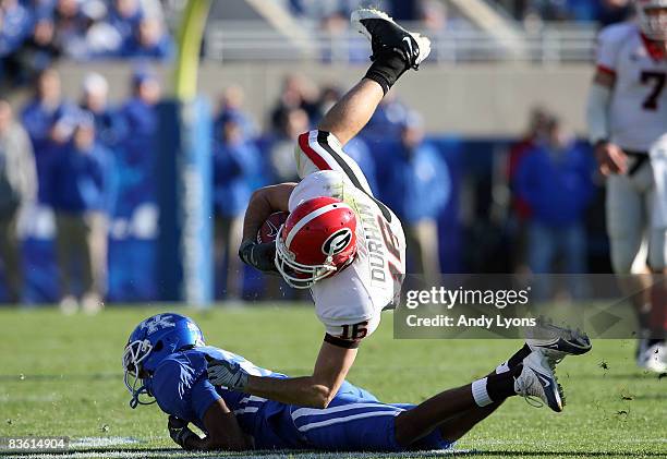 Kris Durham of the Georgia Bulldogs is tripped up during the game against the Kentucky Wildcats at Commonwealth Stadium on November 8, 2008 in...