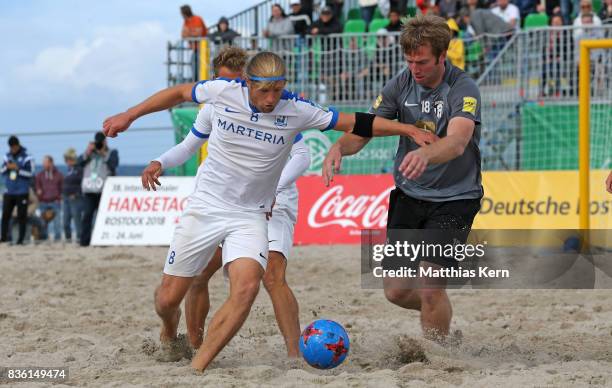 Sebastian Ullrich of Ibbenbueren battles for the ball with Christoph Thuerk of Rostock during the final match between Rostocker Robben and...