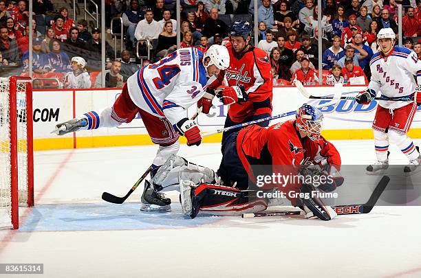 Brent Johnson of the Washington Capitals makes a save in front of Aaron Voros of the New York Rangers November 8, 2008 at the Verizon Center in...