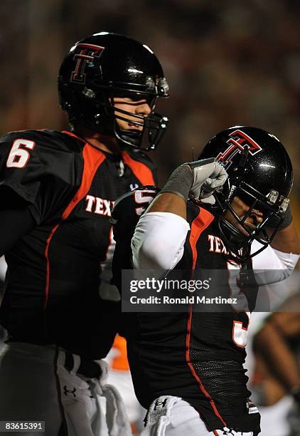 Wide receiver Michael Crabtree celebrates a touchdown with Graham Harrell of the Texas Tech Red Raiders during play against the Oklahoma State...