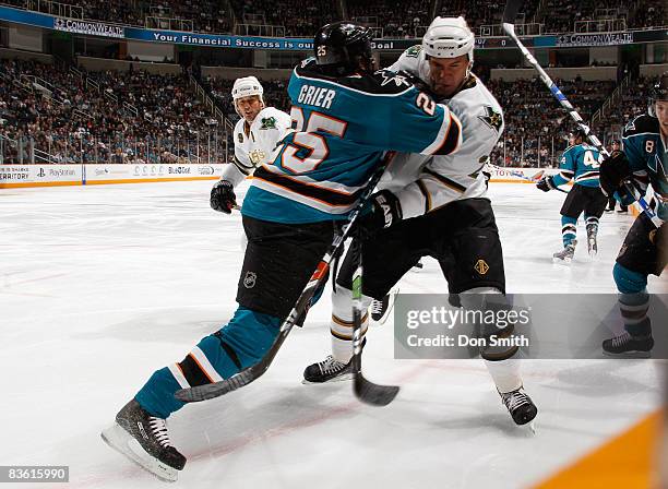 Mike Grier of the San Jose Sharks body checks Niklas Grossman of the Dallas Stars in a very physical first period of hockey during an NHL game on...