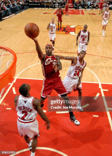 Lebron James of the Cleveland Cavaliers goes to the basket over Ben Gordon and Tyrus Thomas of the Chicago Bulls during the NBA game on November 8,...