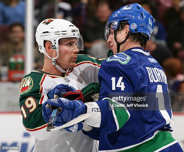 Alex Burrows of the Vancouver Canucks and Stephane Veilleux of the Minnesota Wild exchange words during their game at General Motors Place on...