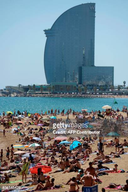General view taken on August 21, 2017 shows the Barceloneta beach of Barcelona with tourists and residents enjoying a sunny day four days after the...