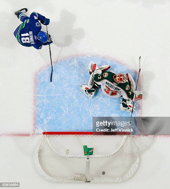 Steve Bernier of the Vancouver Canucks watches the shot of Sami Salo get past Niklas Backstrom of the Minnesota Wild for a Canuck goal during their...