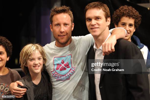 Actor Michael Rosenbaum poses for a photo with Luc Robitaille and son Jesse Robitaille during the game between the St. Louis Blues and the Los...