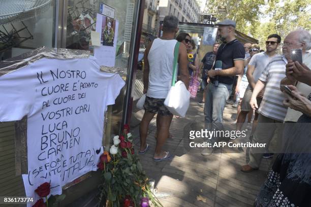 People pay tribute to Italian victim Luca Russo and fellow citizens on the Rambla boulevard in Barcelona on August 21, 2017 four days after the...