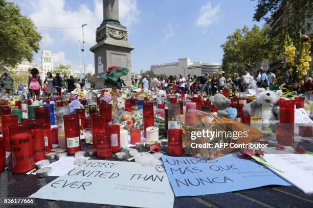 People display flowers, candles, balloons and many objects to pay tribute to the victims of the Barcelona and Cambrils attacks on the Rambla...