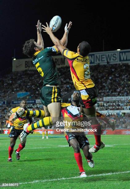 David Willliams of Australia contests a high ball with David Moore of PNG which lead to an Australian try during the 2008 Rugby League World Cup Pool...
