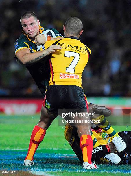 Anthony Watmough of Australia is tackled by Keith Peters of PNG during the 2008 Rugby League World Cup Pool 1 match between Papua New Guinea and the...