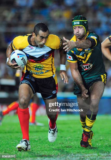 John Wilshere of PNG skips past Johnathan Thurston of Australia during the 2008 Rugby League World Cup Pool 1 match between Papua New Guinea and the...