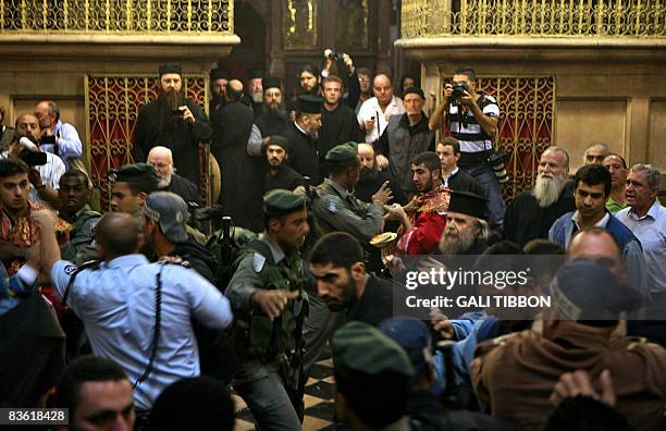 Israeli policemen break a fight between Armenian and Greek Orthodox clergy men at the Church of the Holy Sepulcher in Jerusalem's old city on...