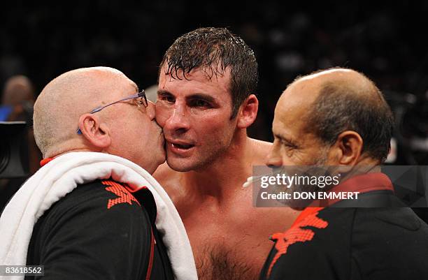 Welshman Joe Calzaghe is congratulated by handlers following his light-heavyweight decision over Roy Jones Jr of the US at Madison Square Garden on...