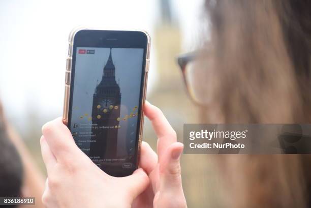 Elizabeth Tower, commonly known as Big Ben is seen through a smartphone screen, in the day of it 'bongs' for the final time for four years, in London...