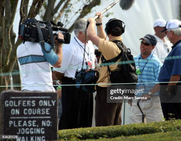 Gregory , who has cerebral palsy, is interviewed by the media as he prepares to walk along the first hole, during the final round at the Children's...