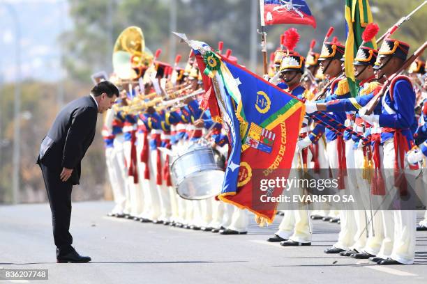 Paraguay's President Horacio Cartes reviews the honour guard during his welcoming ceremony at Planalto Palace in Brasilia, on August 21, 2017. Cartes...