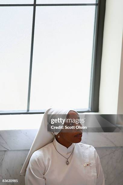 Nation of Islam member listens to a speech by Minister Louis Farrakhan at Mosque Maryam November 09, 2008 in Chicago, Illinois. During his address...