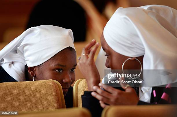 Nation of Islam members chat while waiting for Minister Louis Farrakhan to deliver a speech at Mosque Maryam Novermber 09, 2008 in Chicago, Illinois....