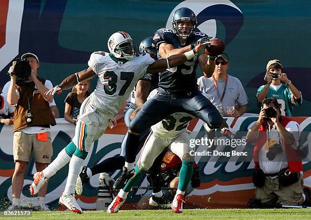 Safety Yeremiah Bell of the Miami Dolphins knocks the ball away from tight end John Carlson of the Seattle Seahawks on a failed two-point conversion...
