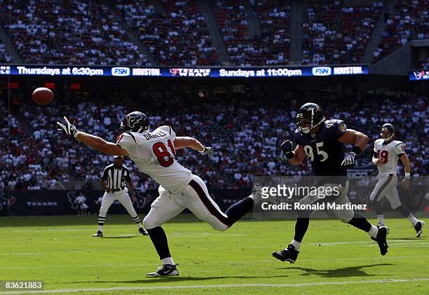Tight end Owen Daniels of the Houston Texans drops a pass while defended by Jarret Johnson of the Baltimore Ravens at Reliant Stadium on November 9,...