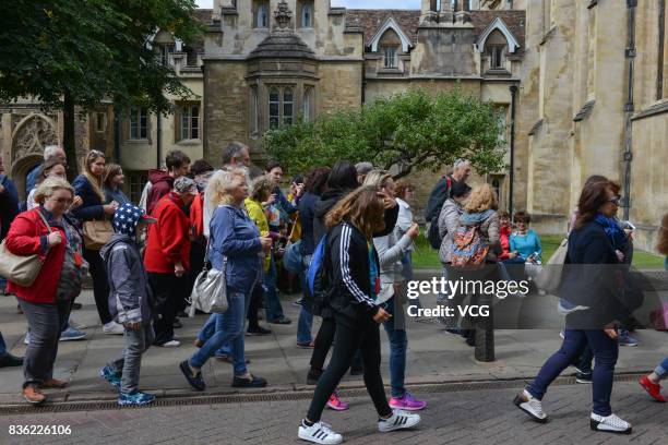 Tourists walk past Isaac Newton's apple tree at Trinity College, part of the University of Cambridge on August 19, 2017 in Cambridge, England. A lot...