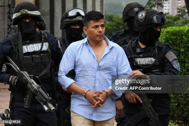 Members of the Honduran elite police unit Tigres escort Sergio Neptali Mejia Duarte, wanted in the US for alleged drug trafficking, before being...