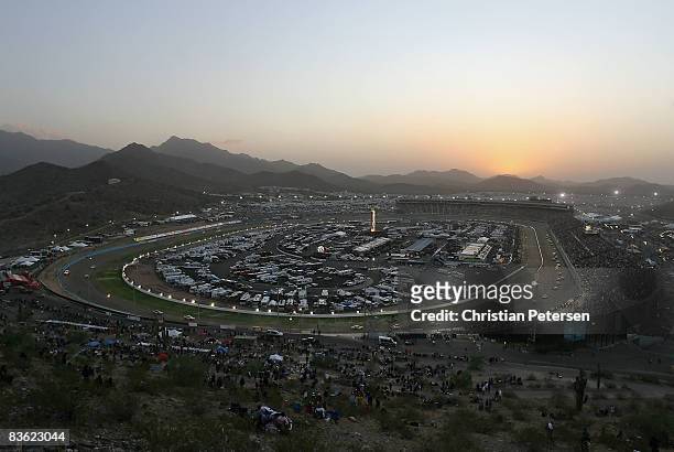 General view of cars racing as the sun sets at the NASCAR Sprint Cup Series Checker O'Reilly Auto Parts 500 at Phoenix International Raceway on...