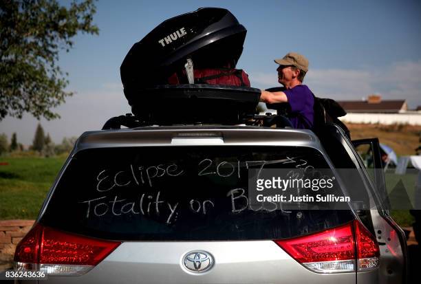 Brian Marriott of Boston, Massachusetts looks in a storage container on top of his car before watching the solar eclipse at South Mike Sedar Park on...