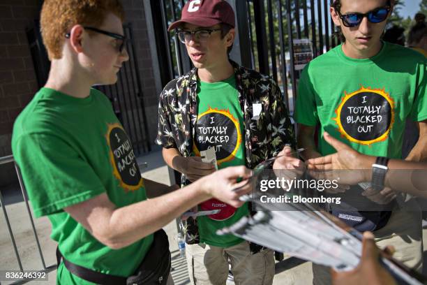 People arrive for a solar eclipse viewing event on the campus of Southern Illinois University in Carbondale, Illinois, U.S., on Monday, Aug. 21,...