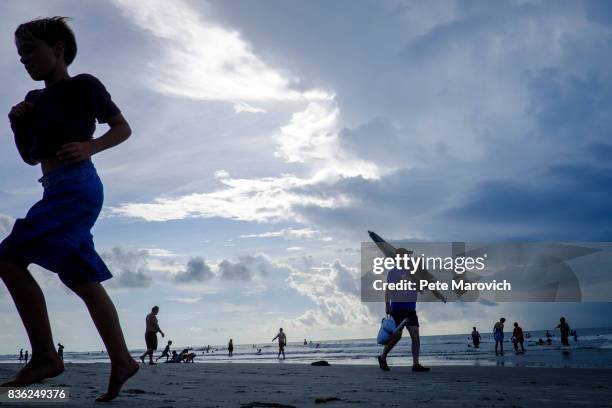 Solar eclipse watchers on the beach hoping to view the total solar eclipse if the weather clears on August 21, 2017 in Isle of Palms, South Carolina....