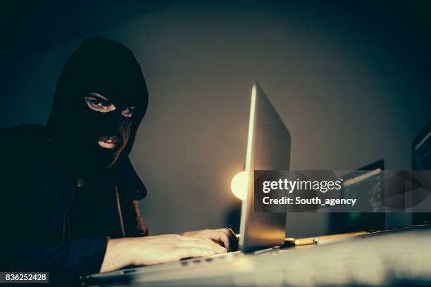 hacker stealing information with laptop - bad passwords stock pictures, royalty-free photos & images