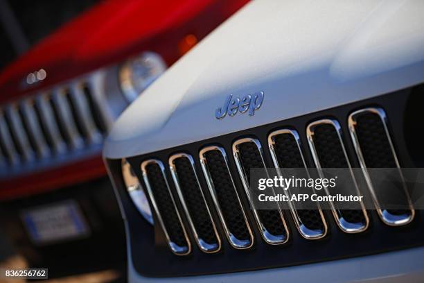 Picture taken on August 21, 2017 at a car dealer in Turin shows the logos of Jeep, brands of Fiat Chrysler Automobiles . / AFP PHOTO / Marco...