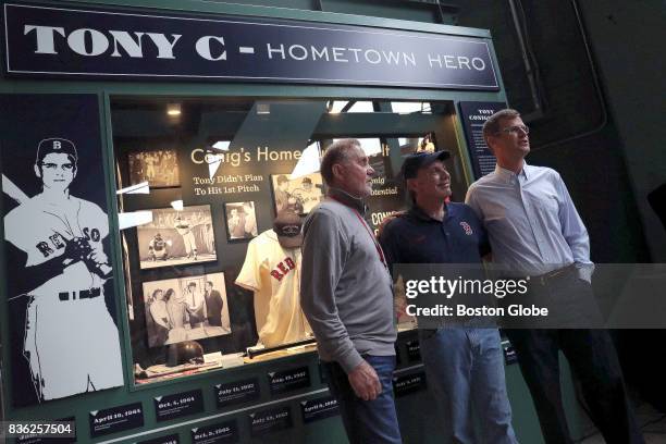 Richie and Billy Conigliaro, younger brothers of late Boston Red Sox star Tony Conigliaro, and Red Sox president Sam Kennedy , pose for a photo after...