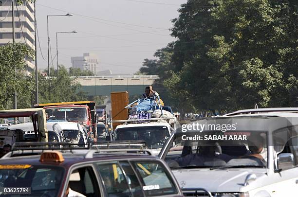 Man rests his head against his hand as he waits in grid lock chocking the streets of the capital Baghdad, the outcome of which sometimes results in...