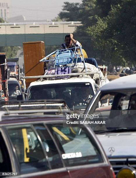 Man rests his head against his hand as he waits in grid lock chocking the streets of the capital Baghdad, the outcome of which sometimes results in...