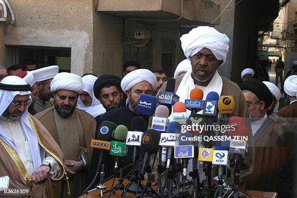 Iraq's Head of Sunni Muslim Endowment movement Sheikh Abdul Ghafur al-Samarrai looks ta his watch as the head of the 'Muslim Hope' in Iraq, Hamid...