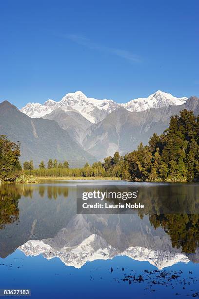mt tasman and mt cook and lake matheson - lake matheson new zealand stock pictures, royalty-free photos & images